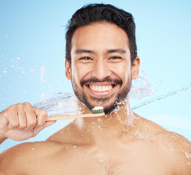 Water splash portrait or man brushing teeth in studio with toothbrush for white teeth or oral healthcare Face tooth paste or happy person cleaning or washing mouth with a healthy dental smile