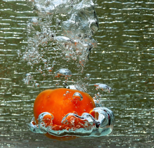 Water splash of a red tomato