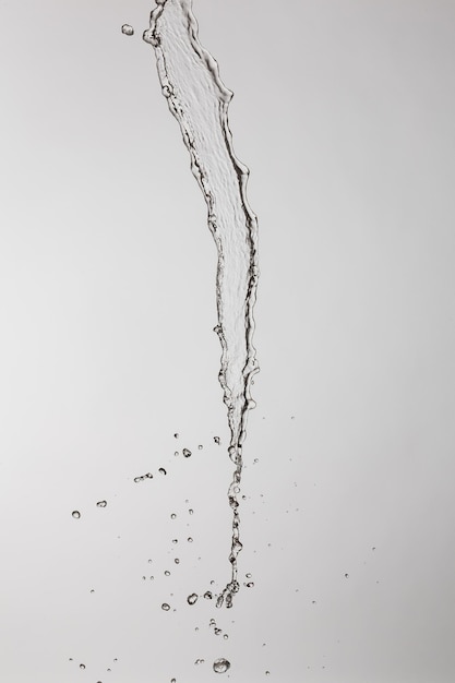 Photo water splash with a lot of drops on a gray background