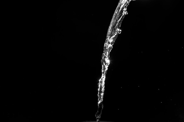 Water splashes isolated on black background white jets with drops