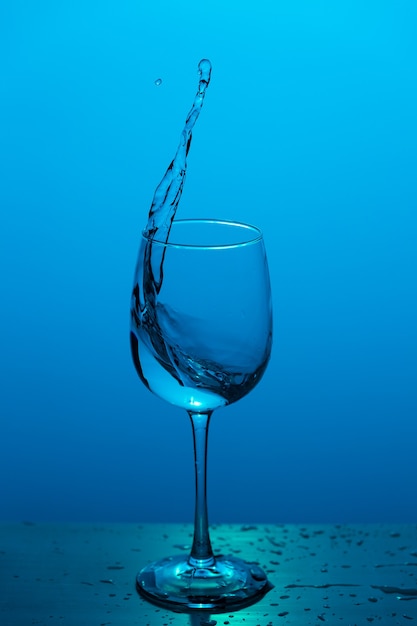 Water splashing out of a wine glass.