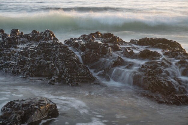 Water splashing on rock at beach