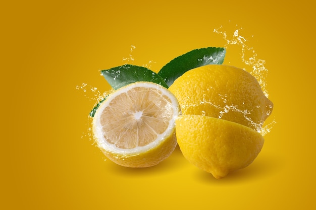 Water splashing on Sliced lemon fruit isolated on yellow background