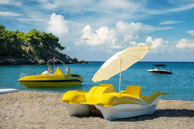 Water sport activities concept beautiful beach with boats and catamaran