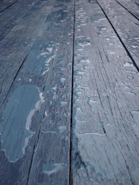 Water spread over old wooden planks painted with gray paint vertical photo for backgrounds