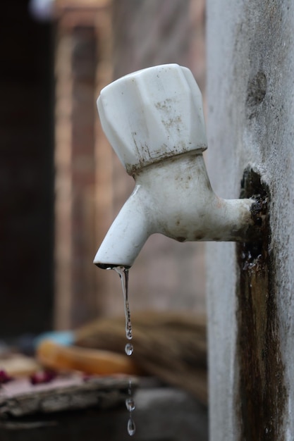 A water tap is being dropped into a sink