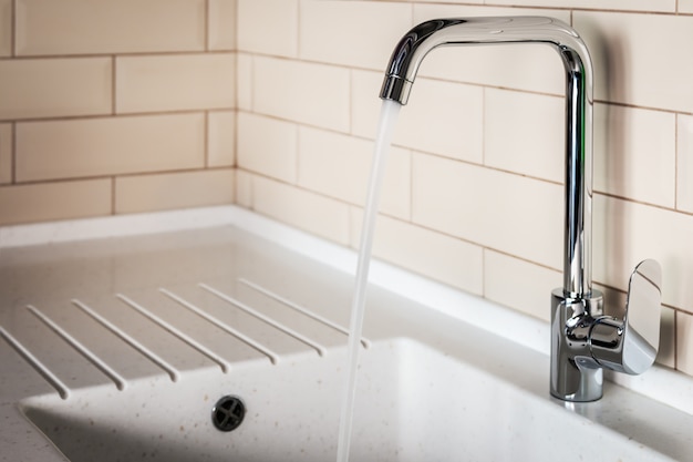 Water tap in the kitchen. water flows from the tap 