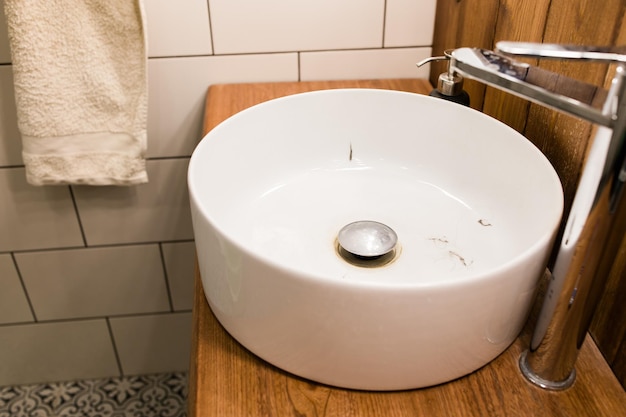 Water tap with dirty sink close up chrome faucet wash basin Hygiene and Cleaning hands and messy home concept