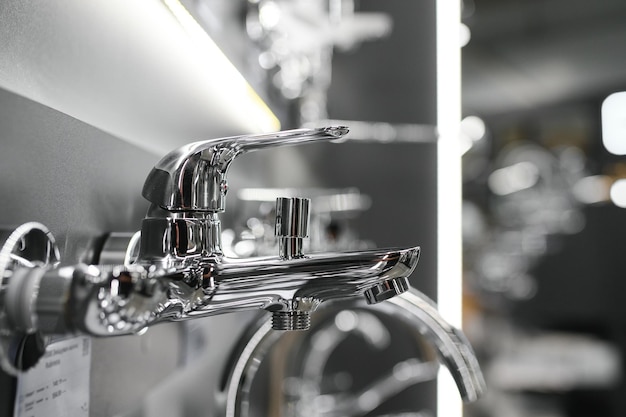 Photo water taps of different types and shapes on the counter in the store retail trade in sanitary ware foreground