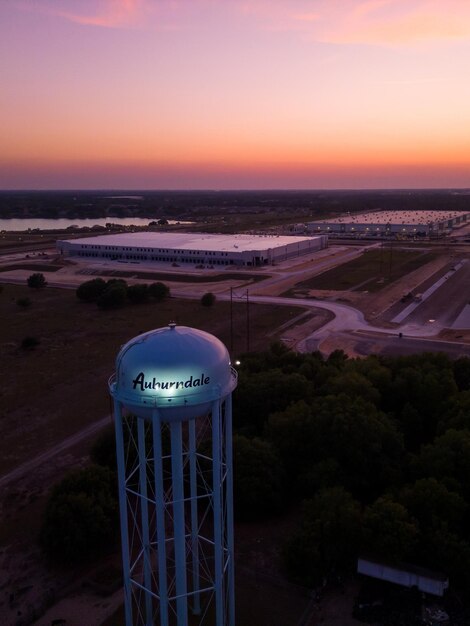 A water tower in the sunset with the words aalborg on the top.