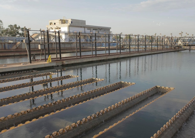 A water treatment plant with a building in the background