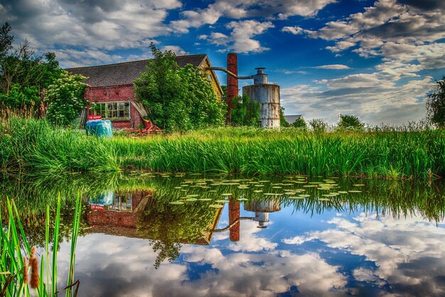 a water view of a farm with a barn in the background