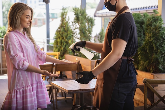 Water werkt met gezichtsmasker in restaurant, uitbraak van coronavirus