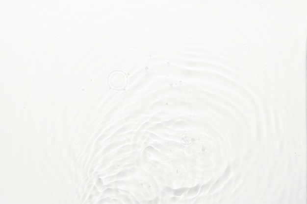 Water white surface abstract background Waves and ripples texture of cosmetic aqua moisturizer with bubbles