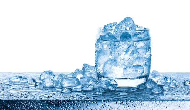 Water with crushed ice cubes in glass on white background