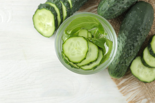 Water with cucumber. Refreshing diet water with cucumber in a glass cup. detox drink concept. top view