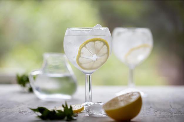 Water with ice and lemon in glass