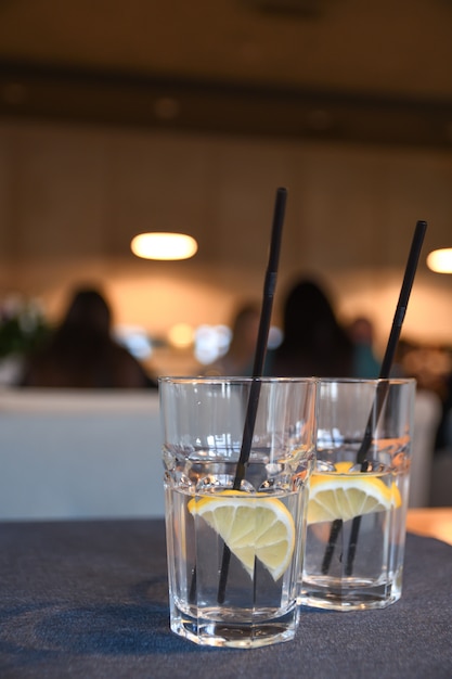 Вода с лимоном, напиток, коктейль на столе в кафе