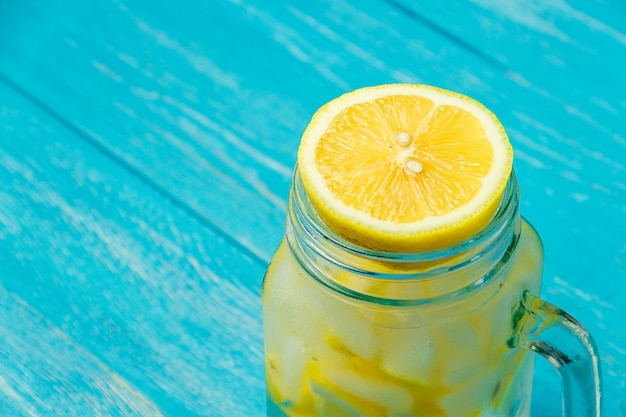Water with lemon. Lemonade with lemon slices