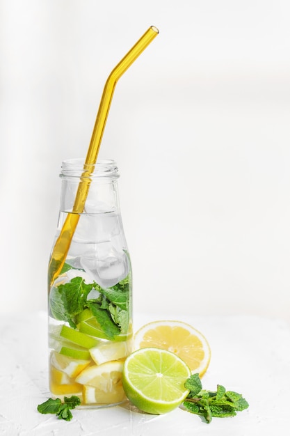 Foto acqua con menta limone lime e ghiaccio con paglia di vetro zero rifiuti