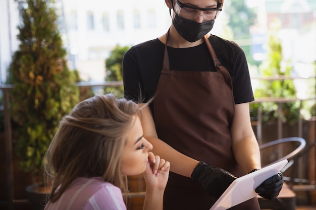 Water working with face mask in restaurant, coronavirus outbreak