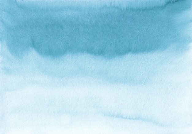 Watercolor blue and white ombre background texture, hand painted. Aquarelle light sea blue gradient backdrop, stains on paper. Artistic painting wallpaper.