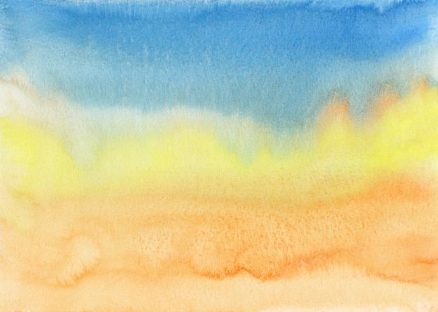 Photo watercolor orange, yellow and blue background texture. bright colorful watercolour stains on paper, hand painted.