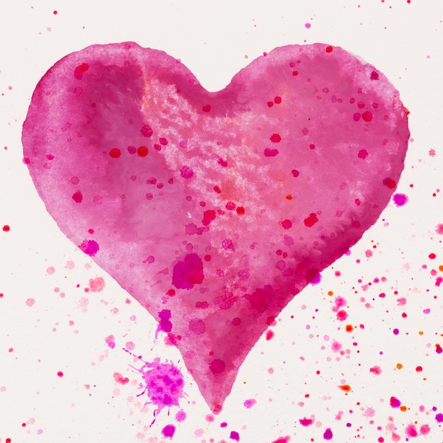 Watercolor painted pink heart on the white watercolor paper