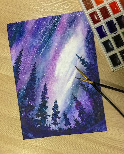 Watercolor painting of a night sky with stars and fir trees