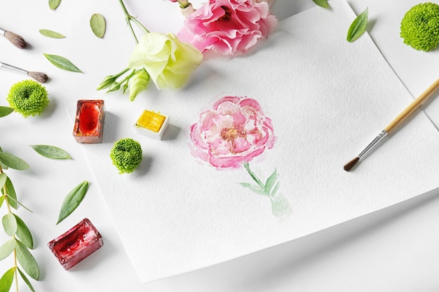 Watercolor painting with flowers on album sheet