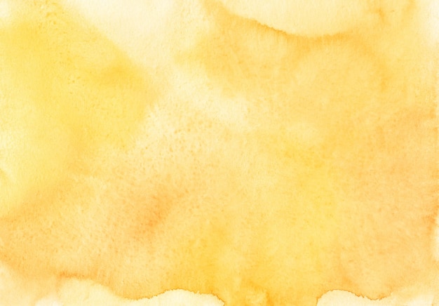 Watercolor vivid yellow background texture. Watercolour golden yellow backdrop. Stains on paper, hand painted.