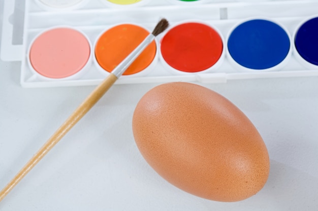 Watercolors and paintbrush for painting a Easter eggs