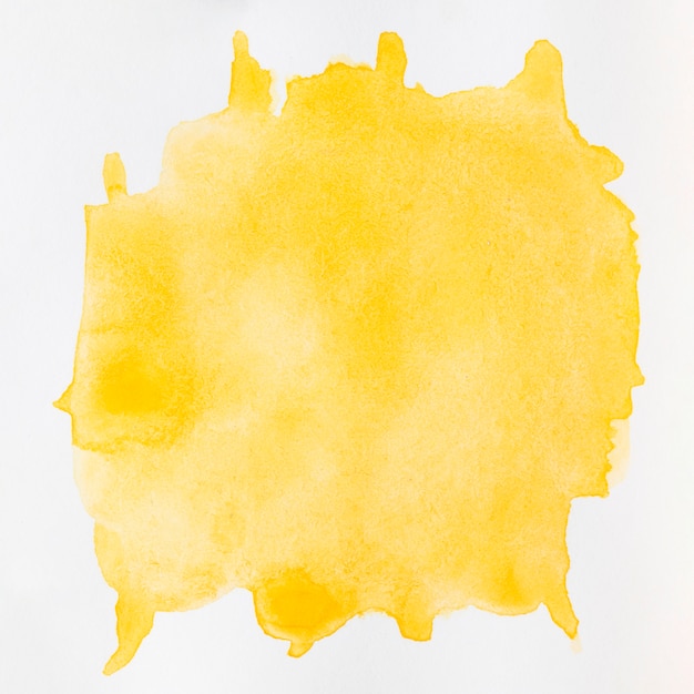 Watercolour liquid yellow splashes on white background