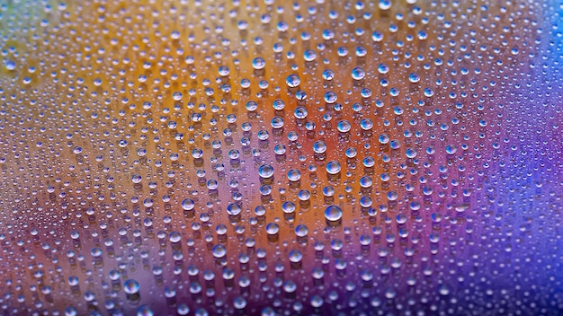 Waterdruppels Druppeltextuur Abstracte achtergrond met kleurovergang Veelkleurige blauwgouden regenbooggradiënt