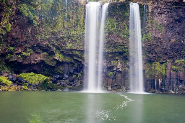 Waterfall cascading over cliff into peaceful pool