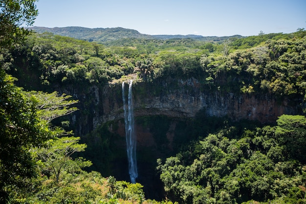 Waterfall flows into the crater of the volcano in Mauritius. National Park Chamarel.