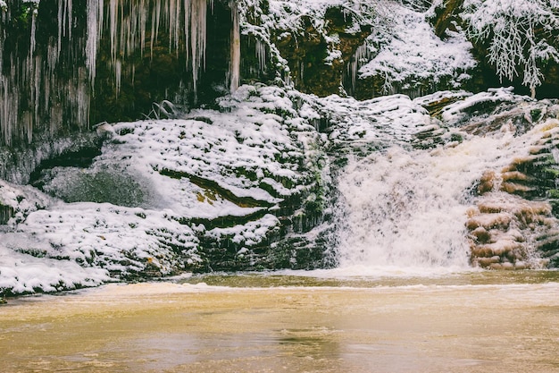 waterfall in the forest on Rufabgo creek in Adygea on a frosty winter morning