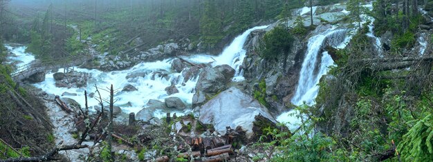 Waterfall in the great cold valley summer cloudy view