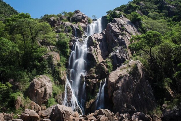 Photo a waterfall is in the middle of a forest with a blue sky