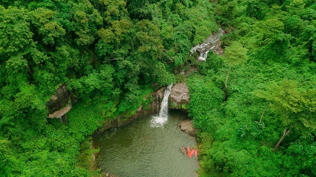 Waterfall in the middle of the forest Bird eye view drone