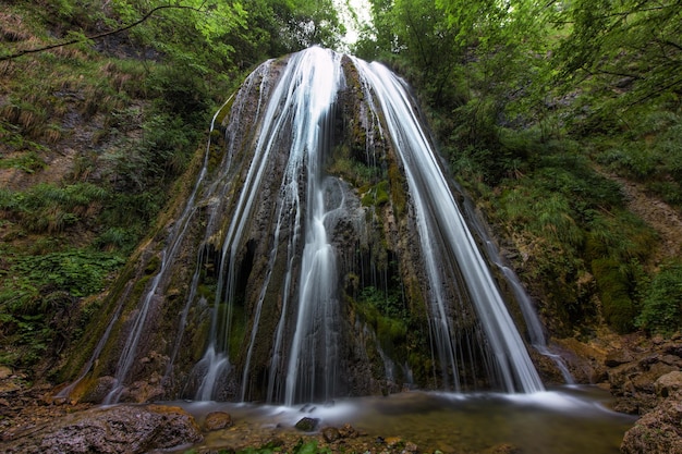 A waterfall in a mountain forest