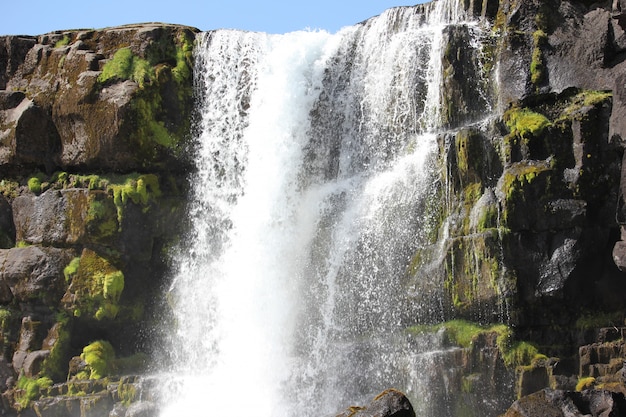 Waterfall on rocks covered by moss