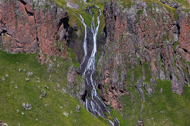 Waterfall on the rocky slopes of the Caucasus Mountains in Russia.