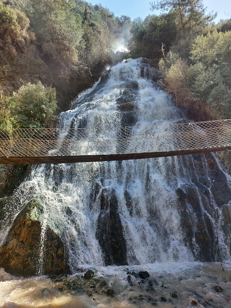 A waterfall with a sign that says'the river is falling '