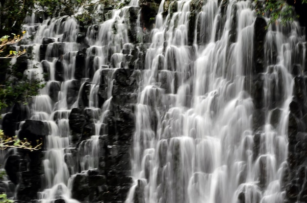 Waterfall with slow motion to create milky water, high mountain and water cascading in milky way