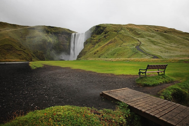 Waterfalls on a mountain with a bench