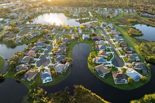 Waterfront single family homes in Florida residential area at sunset Real estate development in American suburbs