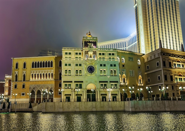 Waterfront and Venetian Macao Casino and luxury resort in Macau, China. Late in the evening. Golden light illumination