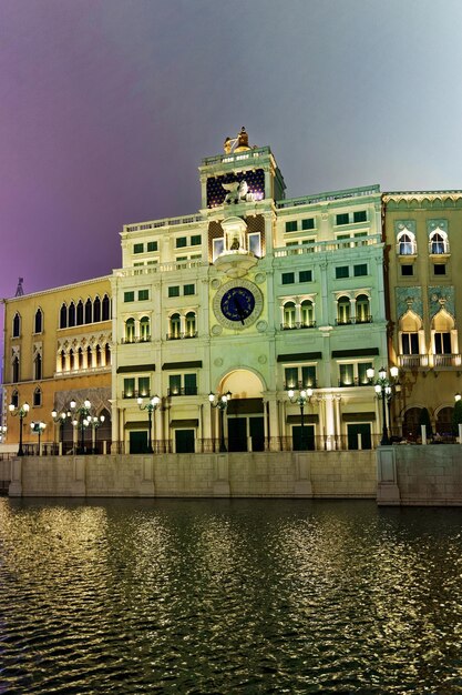 Waterfront and Venetian Macao Casino and luxury resort at Macau, China. Late in the evening. Golden light illumination