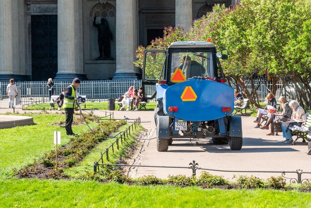 Watering flower beds by city improvement workers in the center in St Petersburg Russia 2022